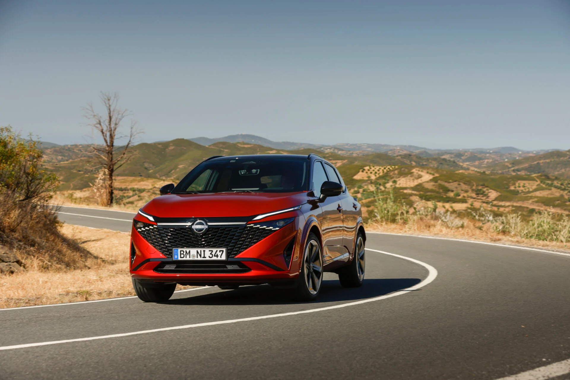 1. New refreshed Qashqai 2024 in fuji sunset color driving on the road in Faro, Portugal