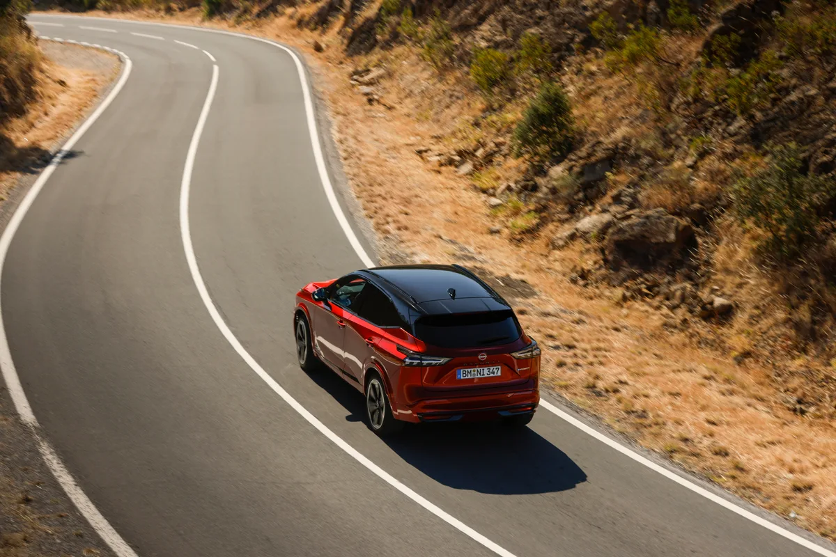 6. New refreshed Qashqai 2024 in fuji sunset color driving on the road in Faro, Portugal