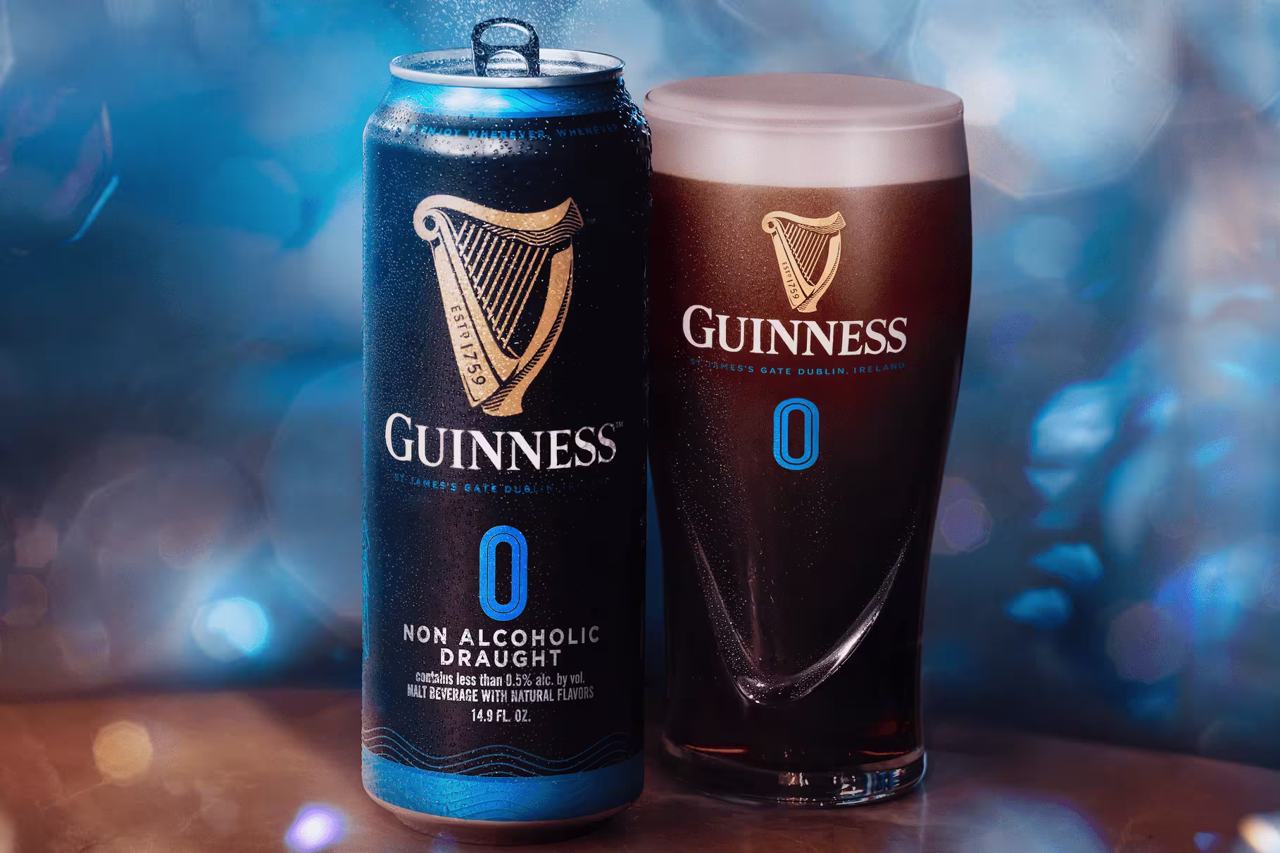 arafed glass of guinness beer next to a can of guinness