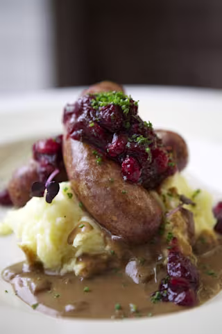 there are some food on a plate and a glass of beer