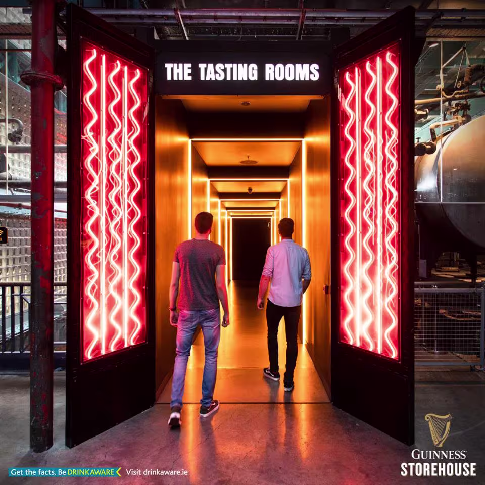 doorways with red lights and a couple of people walking through them
