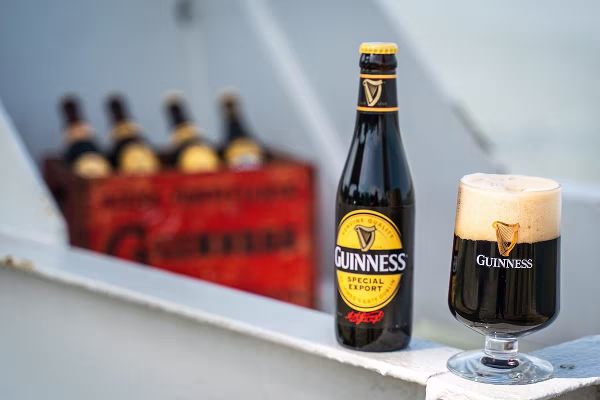 there is a bottle of guinness beer next to a glass of beer