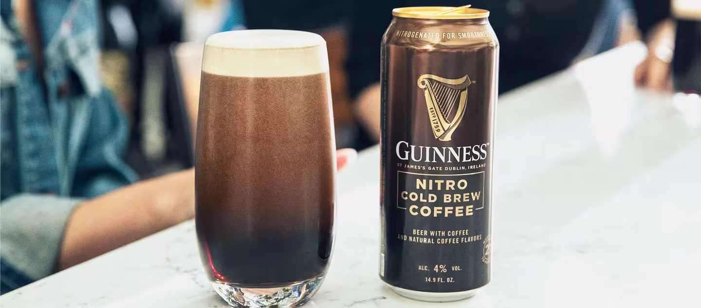 there is a can of guinness next to a glass of coffee