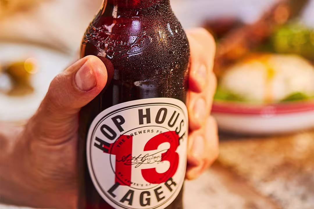 someone is opening a bottle of beer with a bottle opener