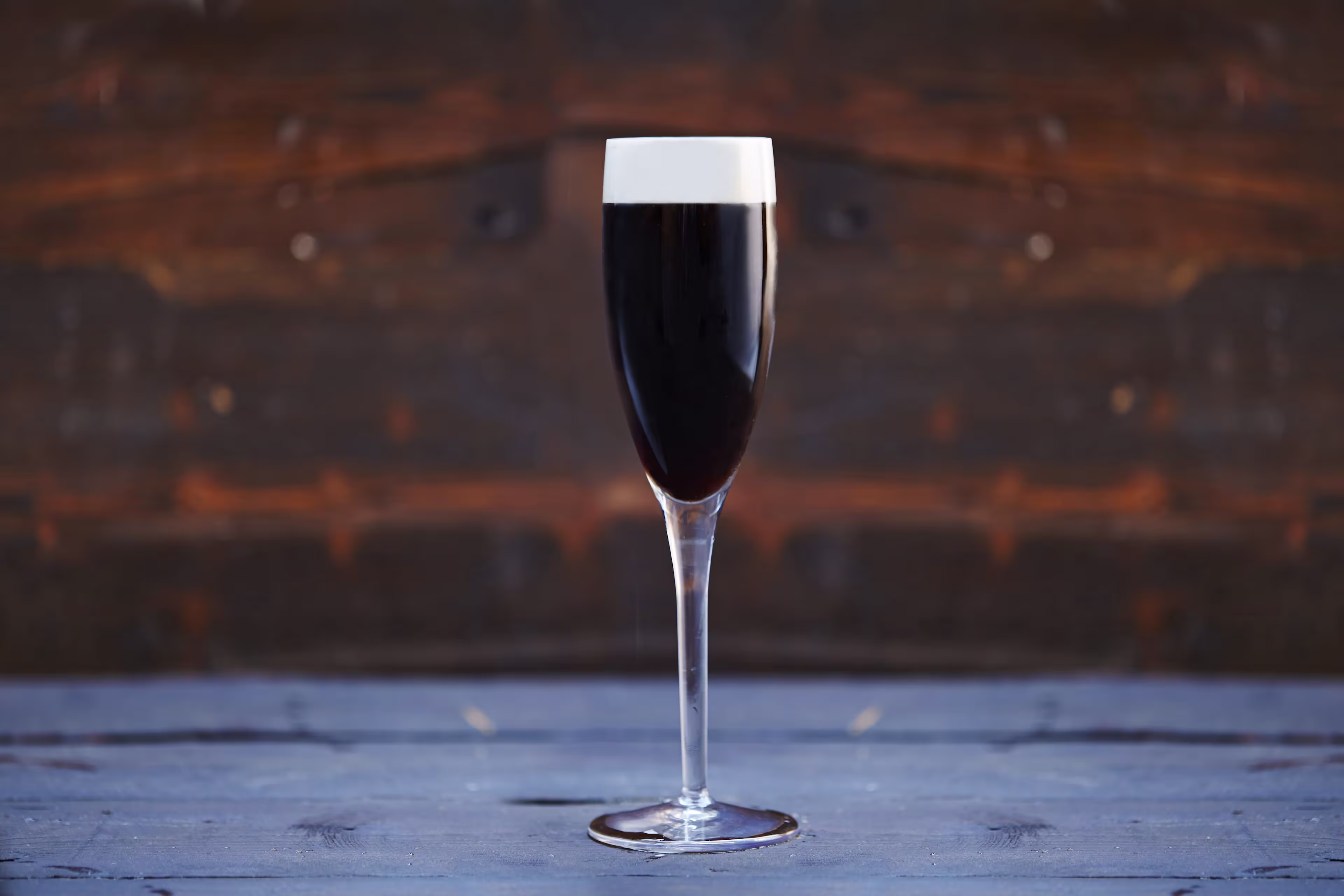 there is a glass of wine sitting on a table