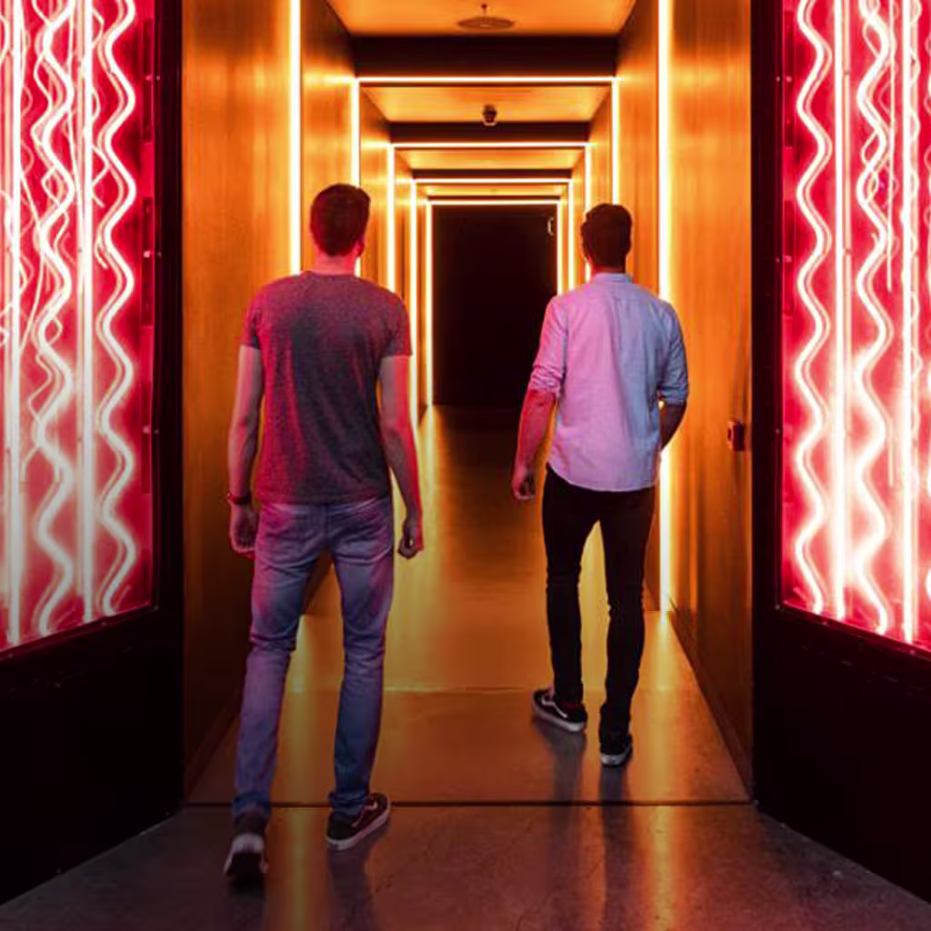Photo of 2 man standing back to camera