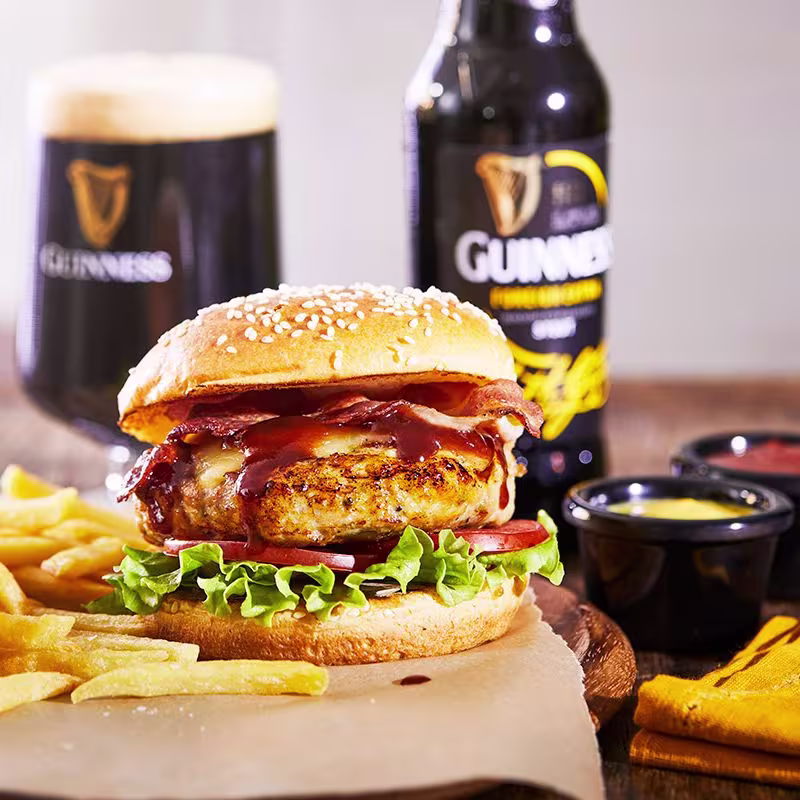 there is a chicken sandwich with lettuce and tomato on a bun