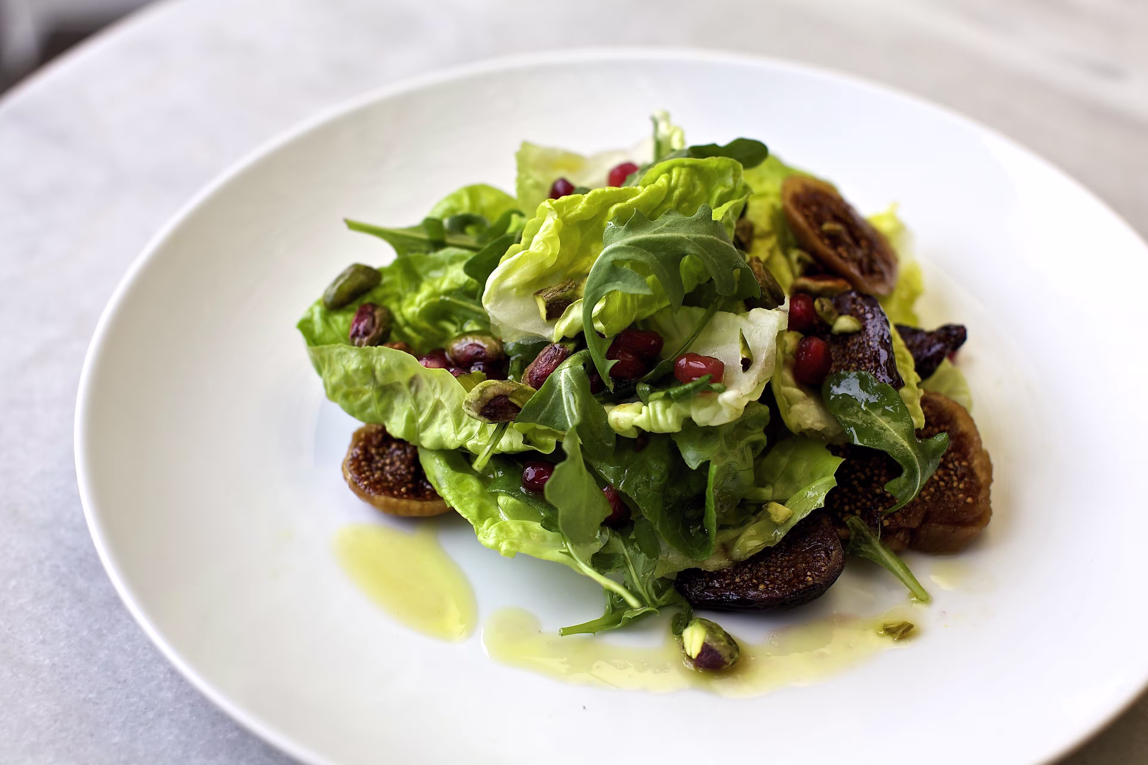 there is a white plate with a salad on it