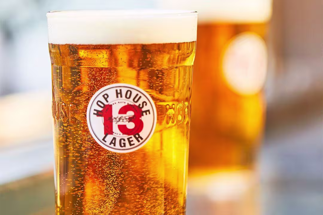 there are two glasses of beer sitting on a table