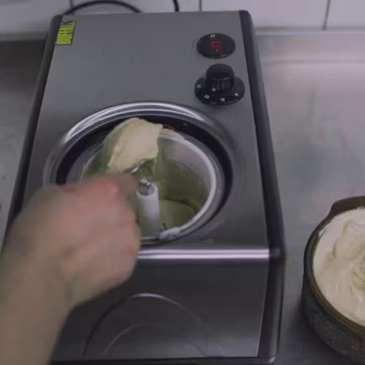 Someone is making a cake with a blender