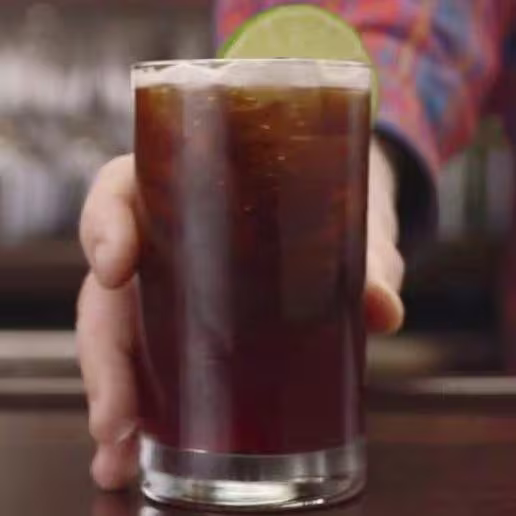 there is a chocolate cake with chocolate frosting and a raspberry on top
