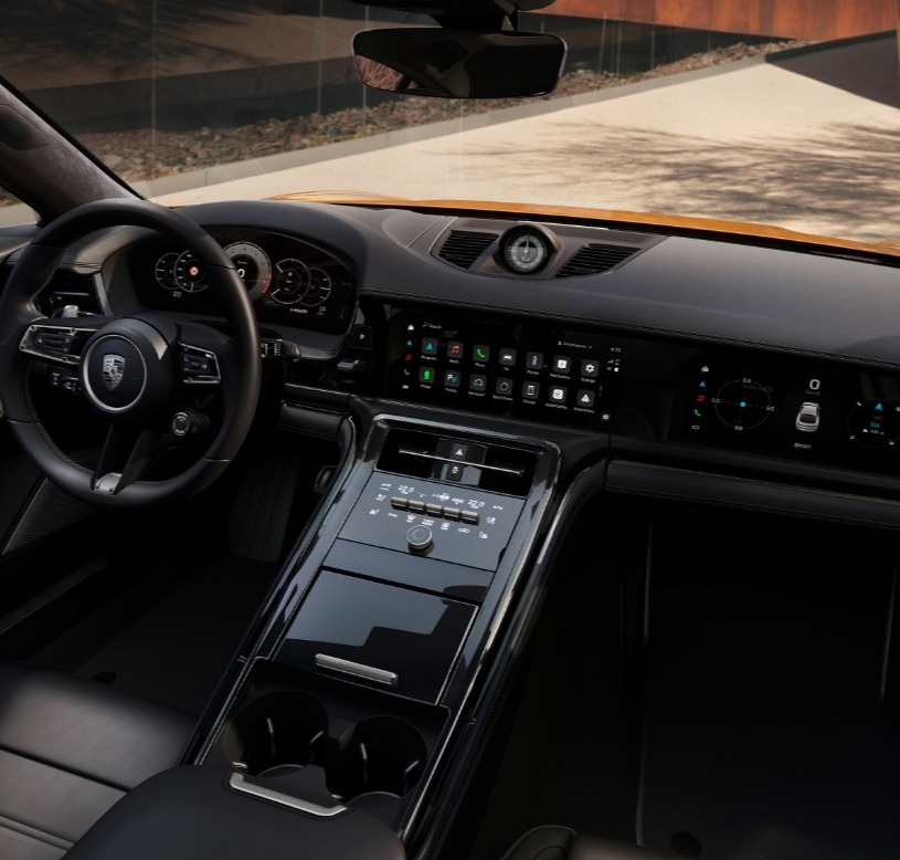 Showing the interior of a panamera, focusing on the front row, showing the wheel and display.