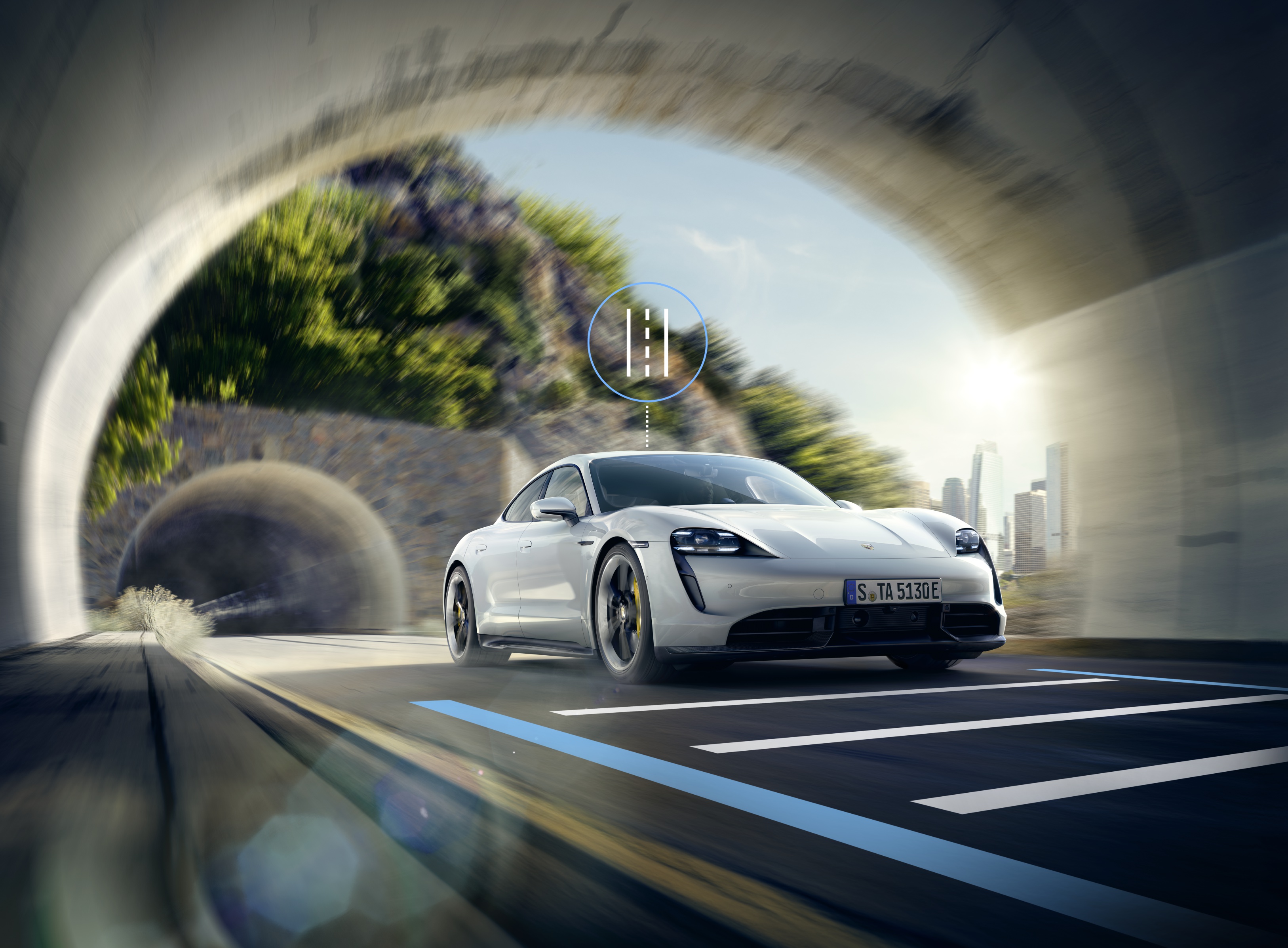 Grey Porsche Taycan driving through a tunnel