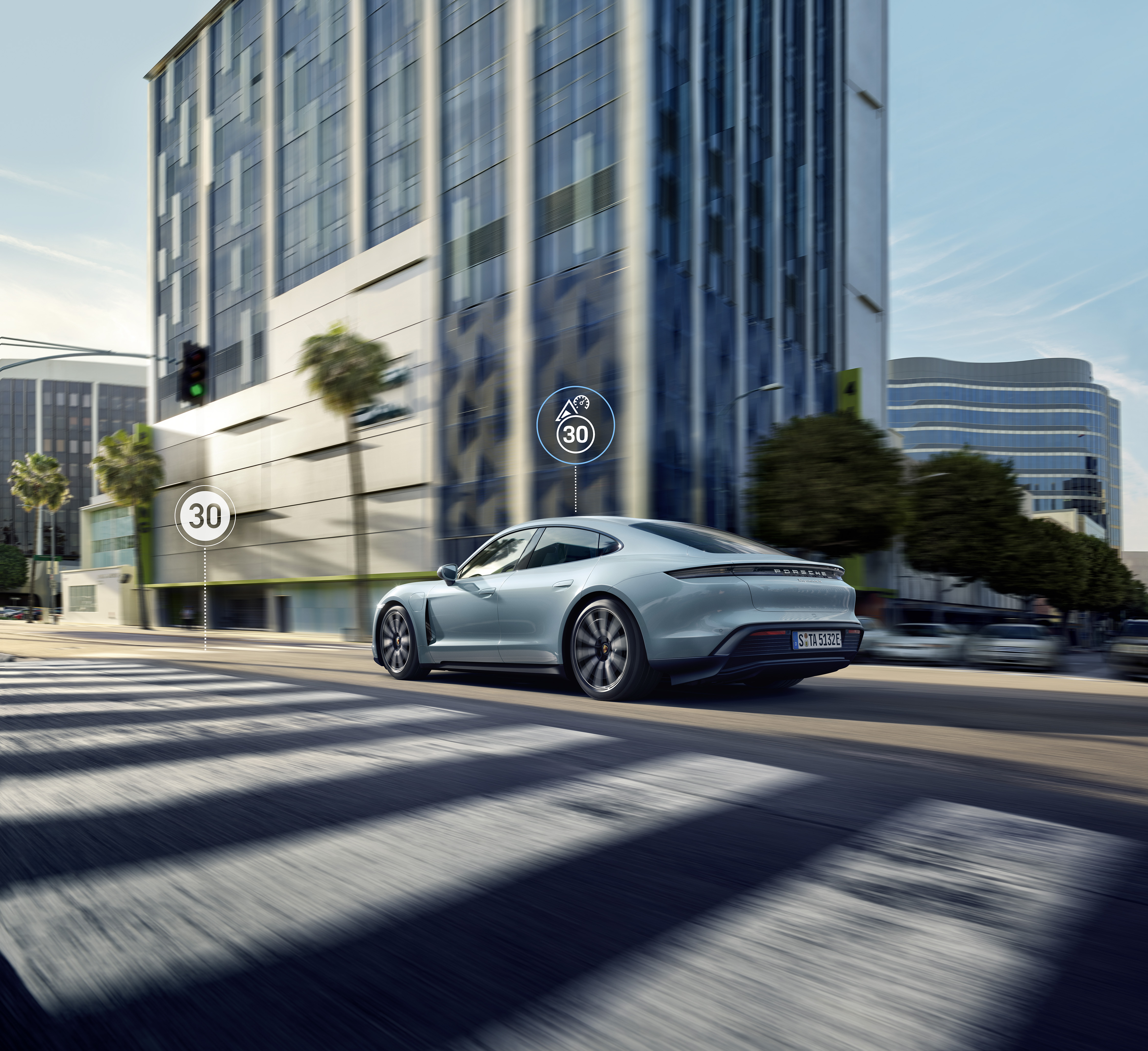 Grey Porsche Taycan driving along a road