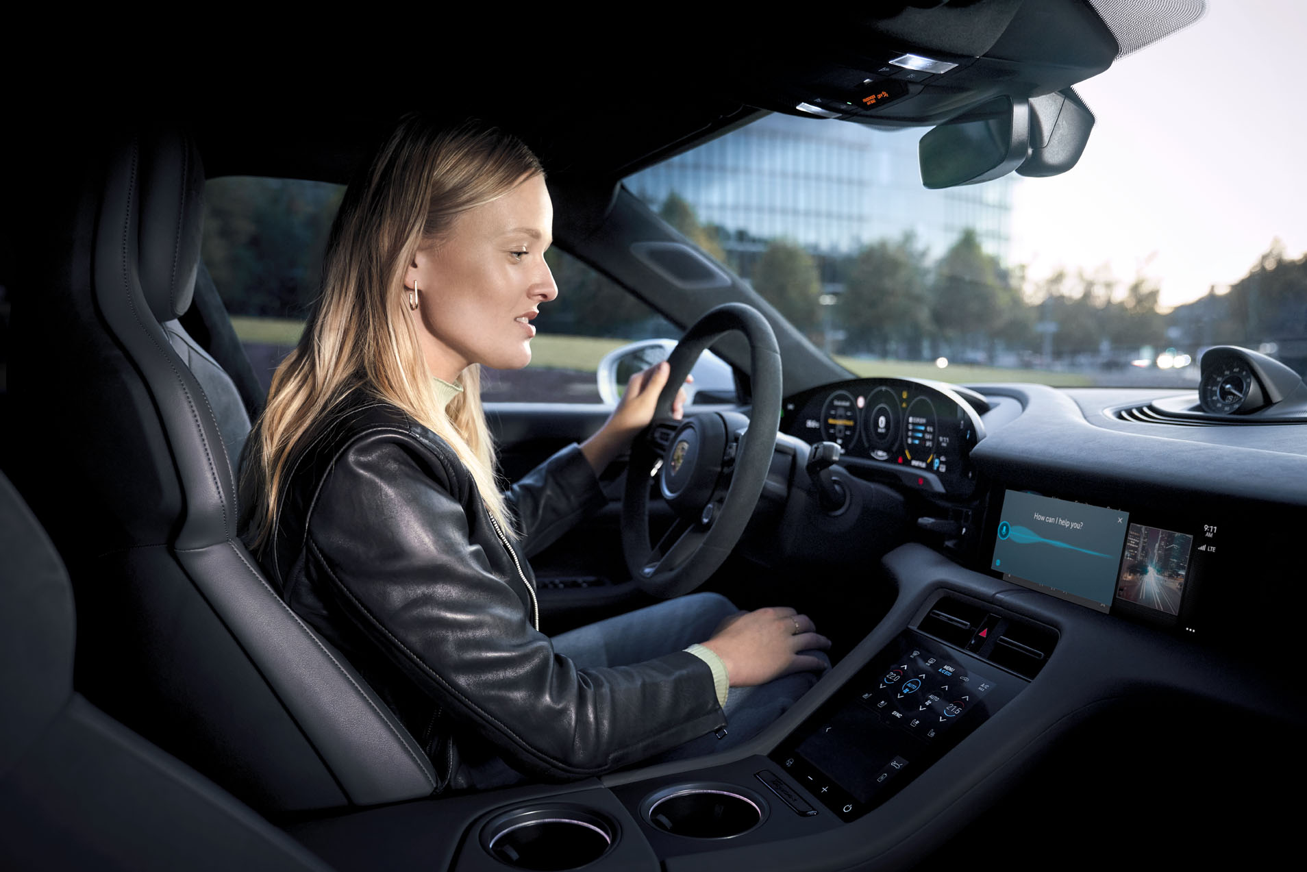 A woman sitting in a Porsche Taycan