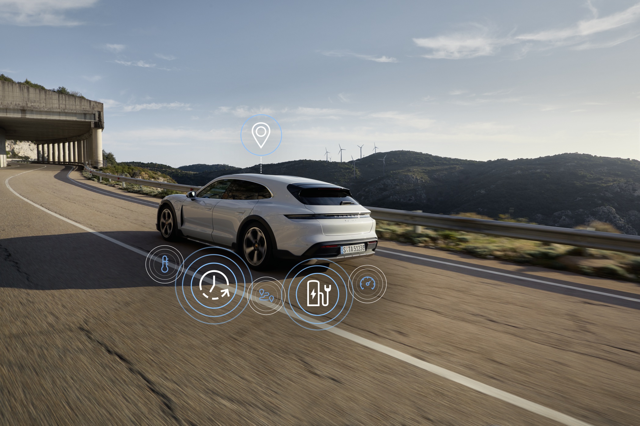 White Porsche Taycan driving along a road
