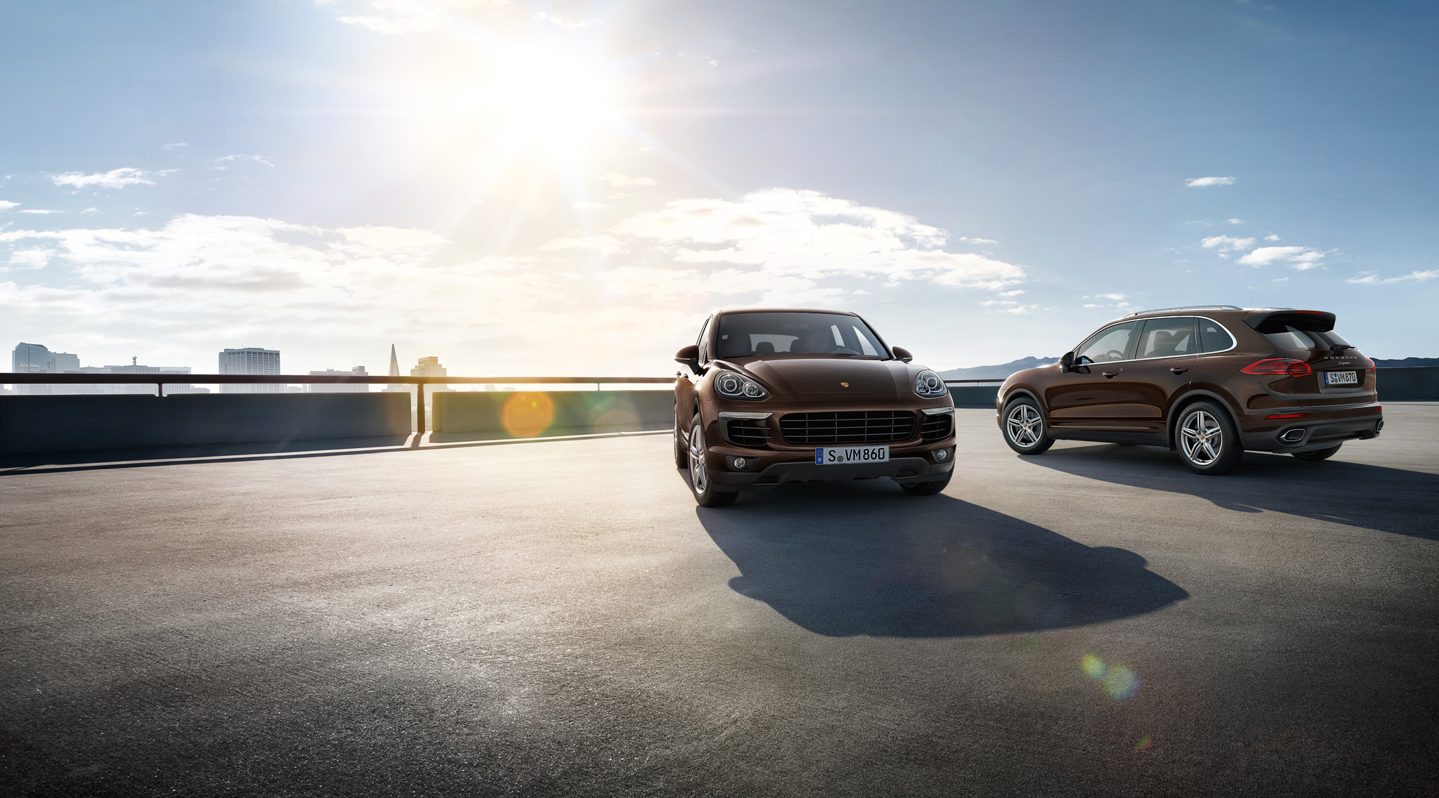 Two brown Porsche Cayenne parking o a parking deck