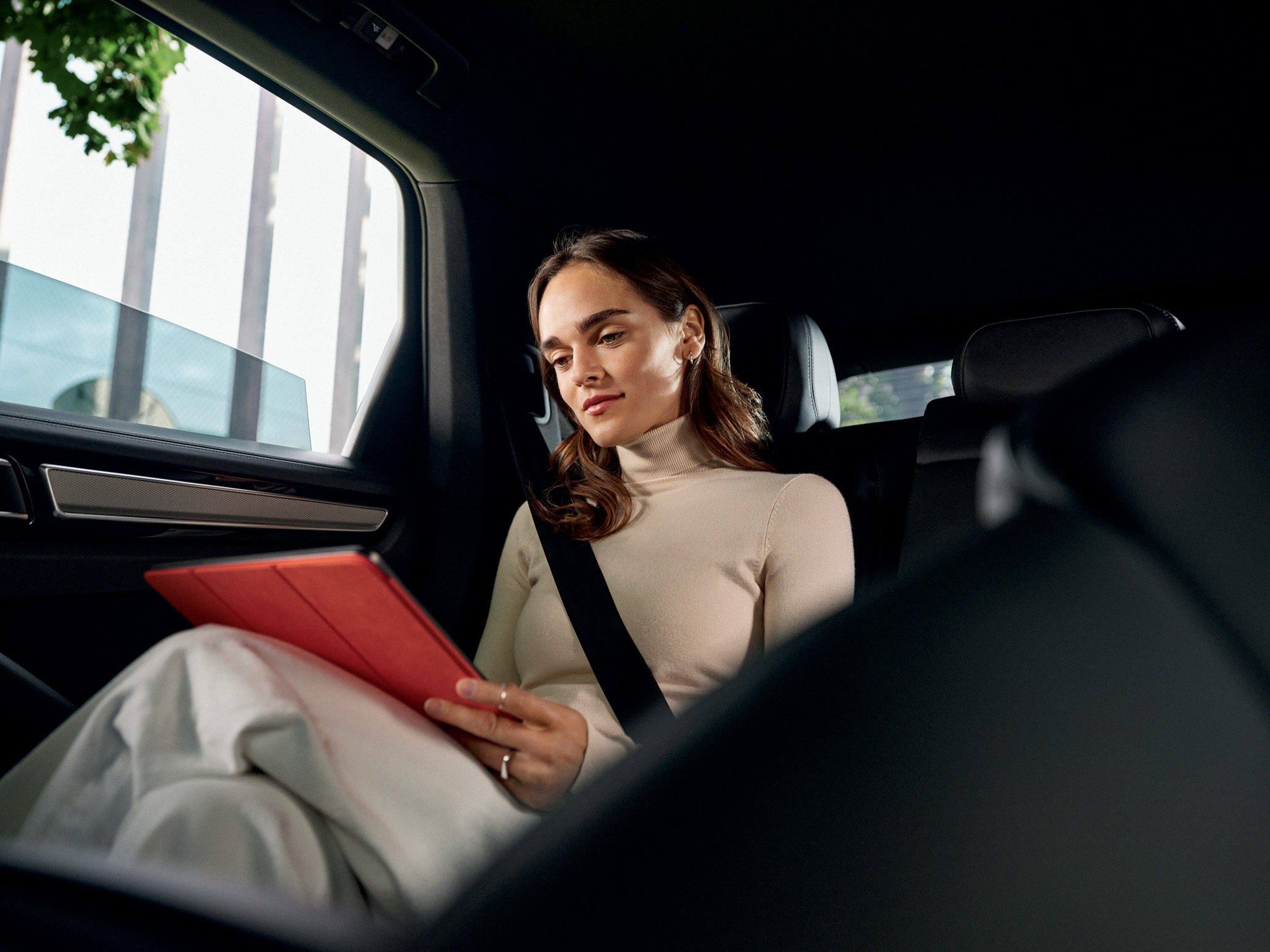 Woman sitting in a Porsche Taycan