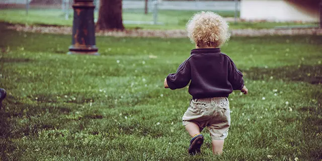 Young child running on grass