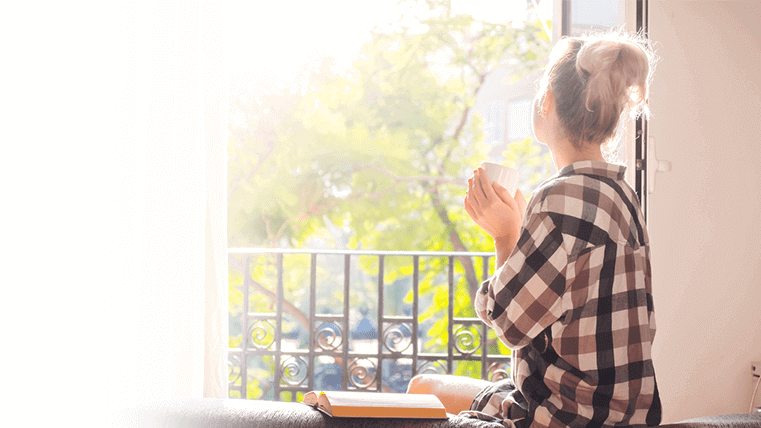 Woman looking out window