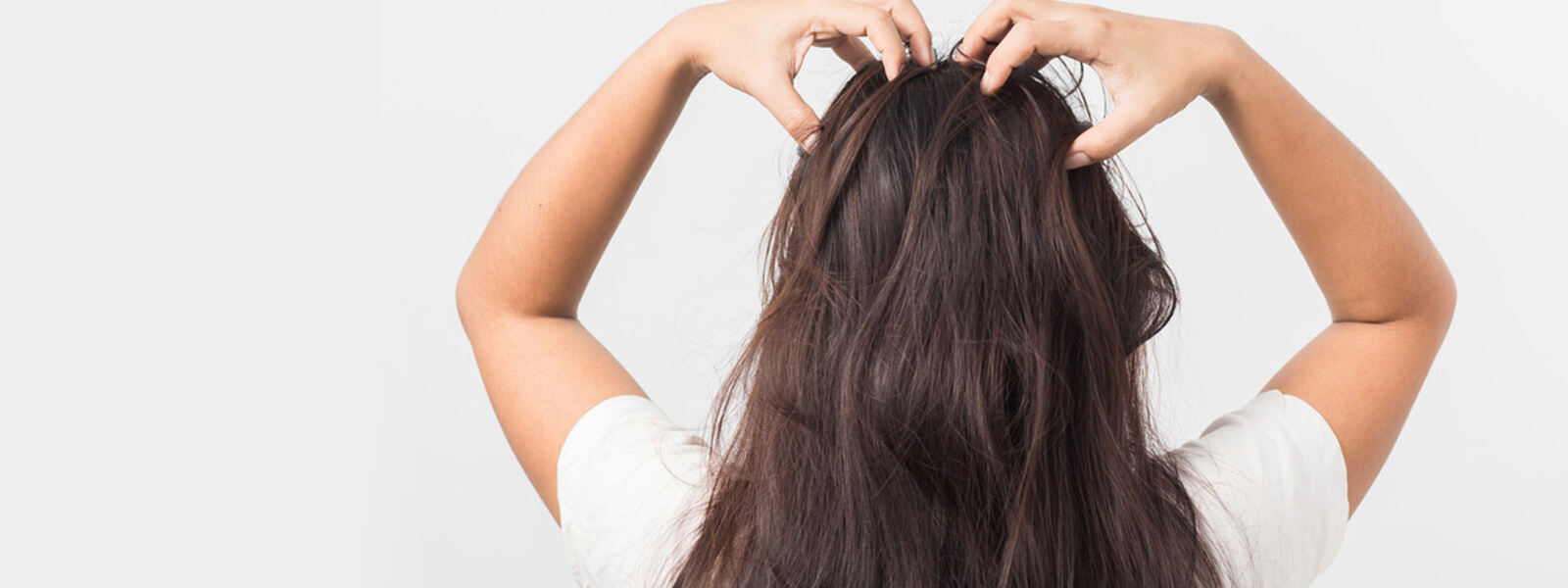 brunette woman with hands on top of her head