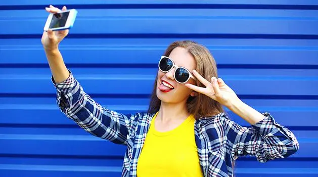 Girl with sunglasses taking a selfie