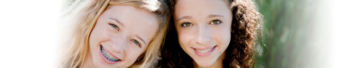 Close-up of two yound girls smiling