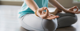 Person sitting cross legged while meditating