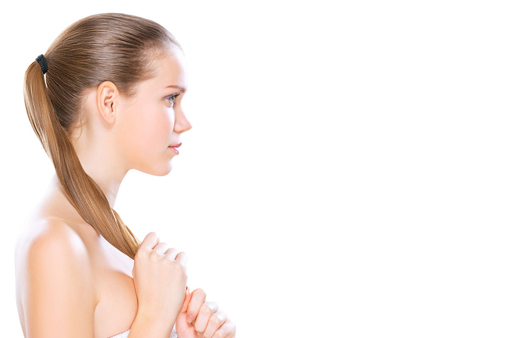 young woman holding her ponytail