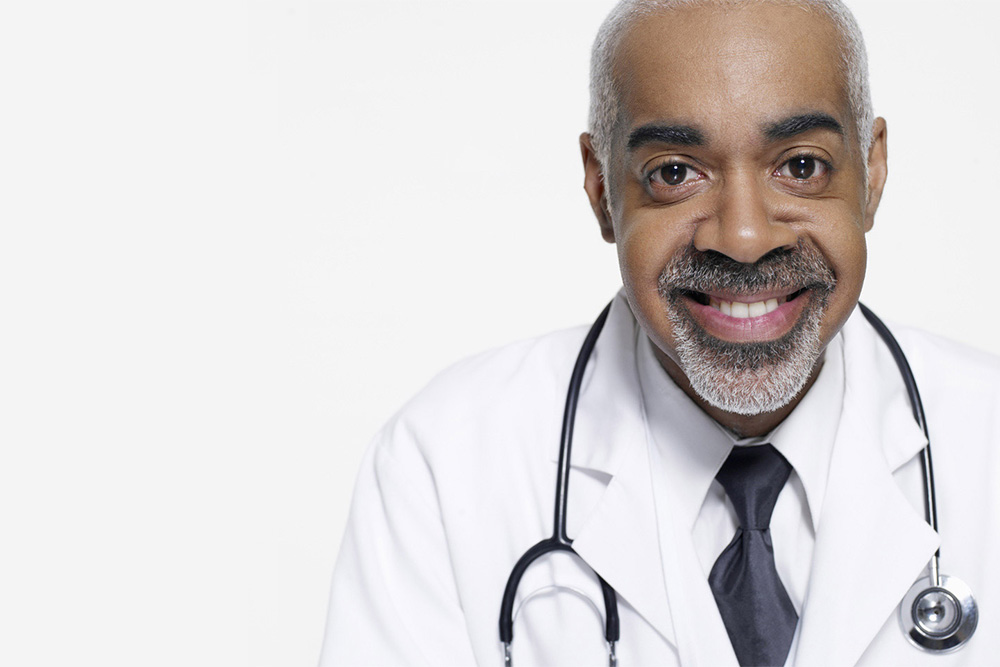 doctor with a black die and stethoscope over his neck