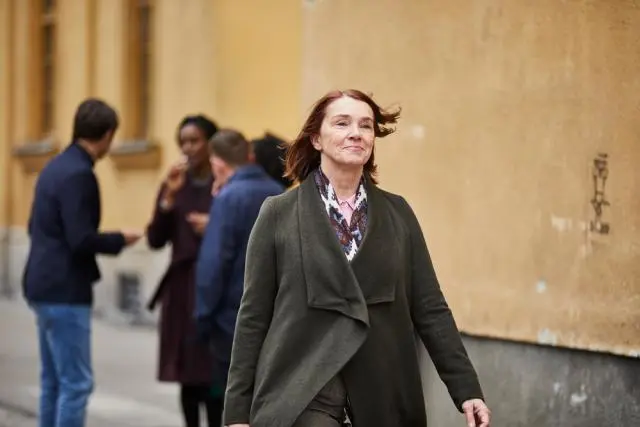Woman walking, other figures in the background