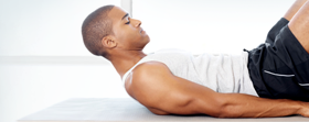 Man on yoga mat doing ab exercise