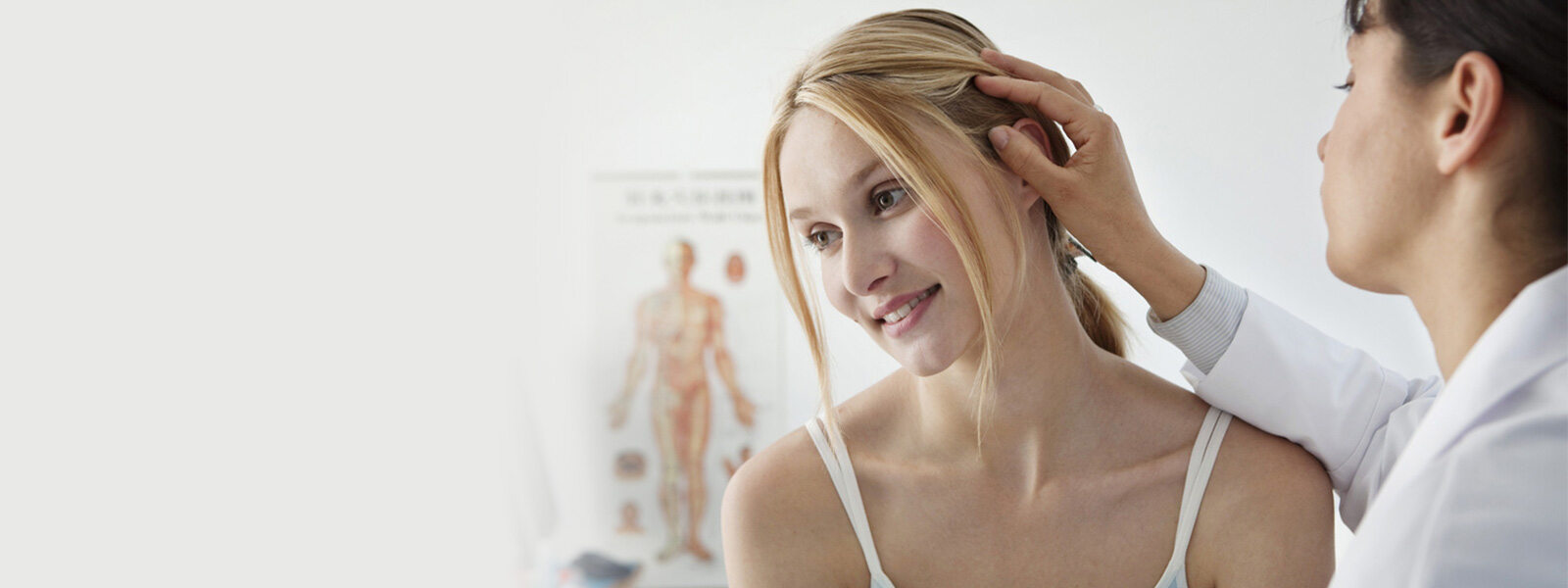 doctor checking womans hair for hair loss