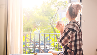 Woman looking out window