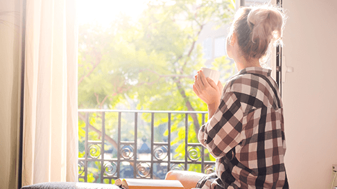 Woman looking out window