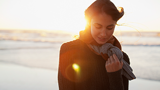 Woman on a beach with a sunset