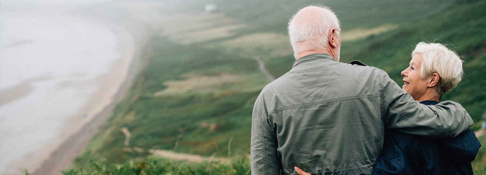 older adult couple hugging