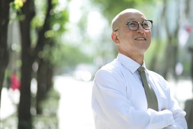 Man with glasses crossing his arms