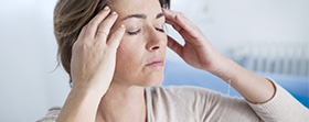 Woman massaging her temples