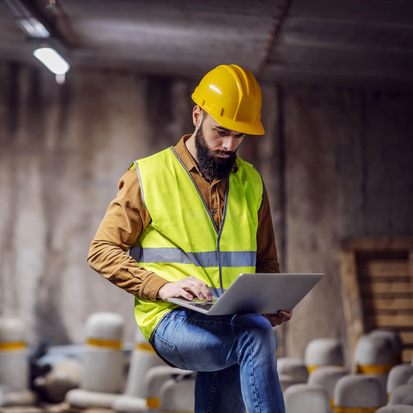 Contractor working on his laptop on site