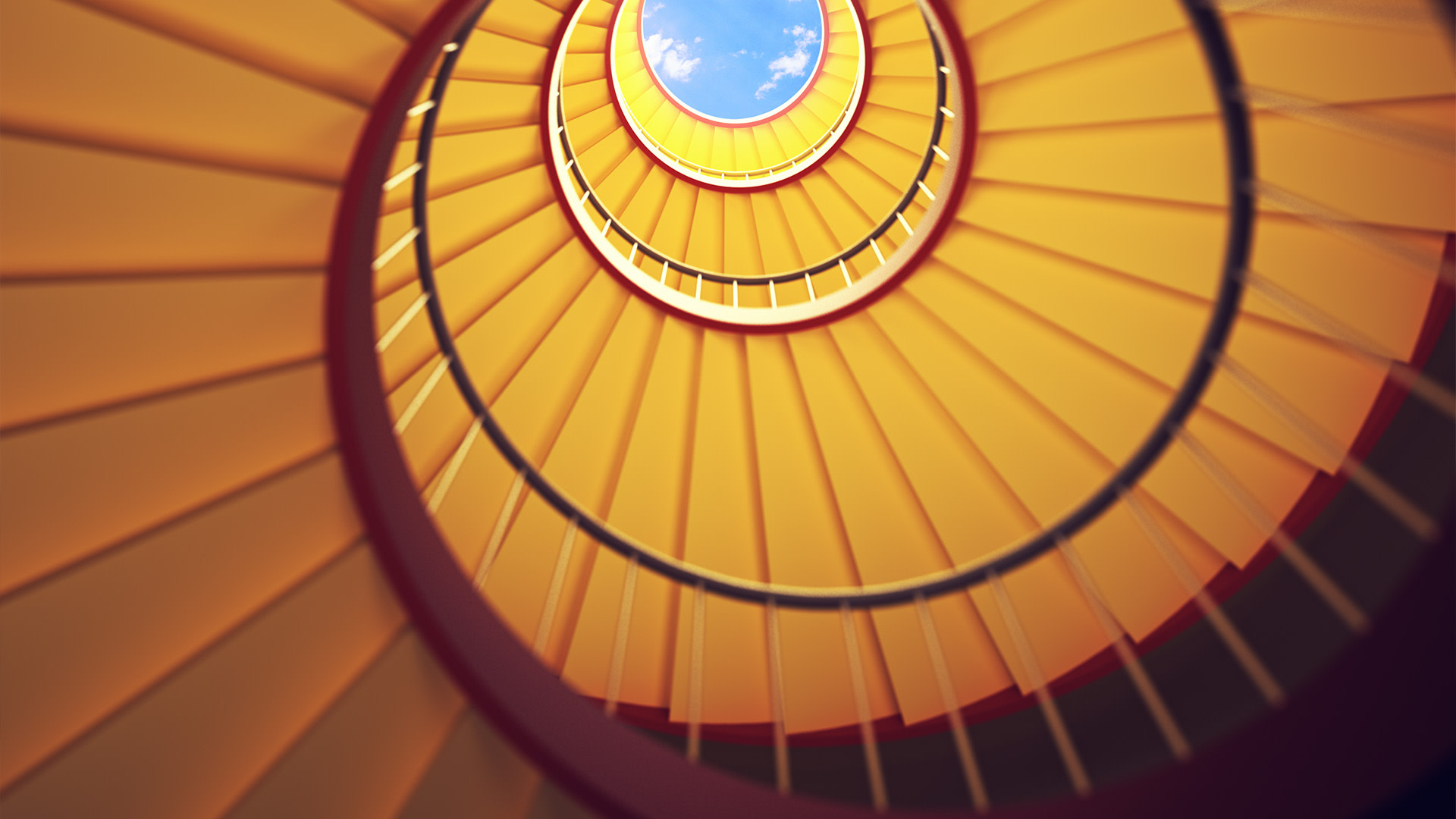 a spiral staircase with a blue sky