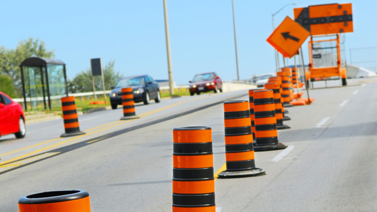 a road with traffic cones and signs