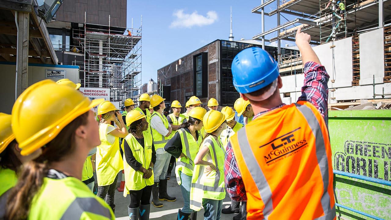 Contractor explaining work to site visitors