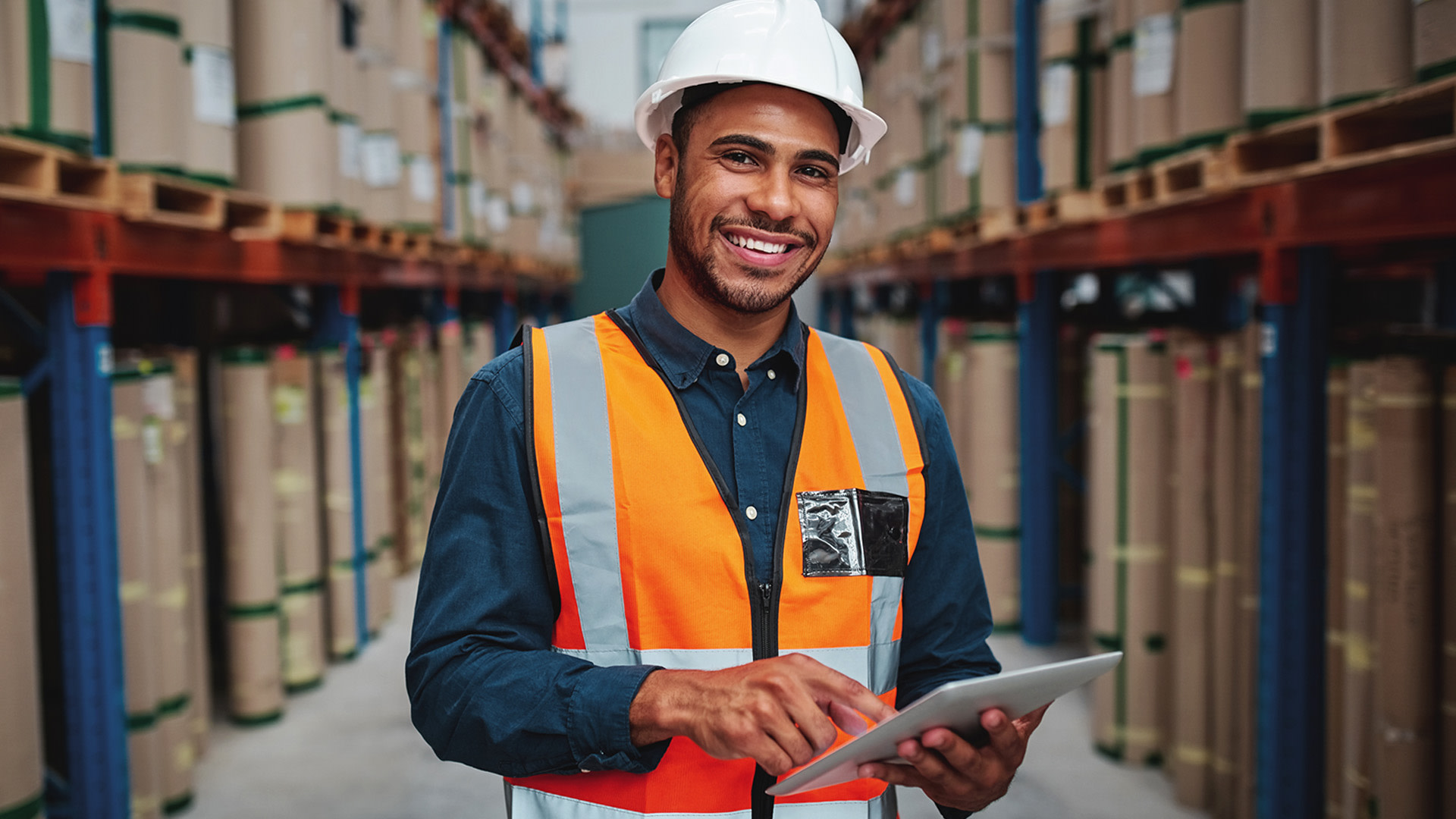 Contractors using a tablet at a warehouse