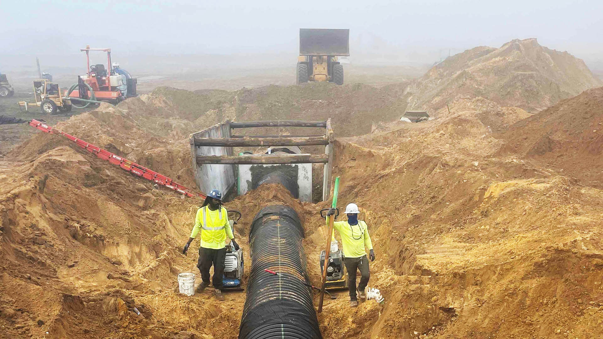 Construction workers installing a pipe system