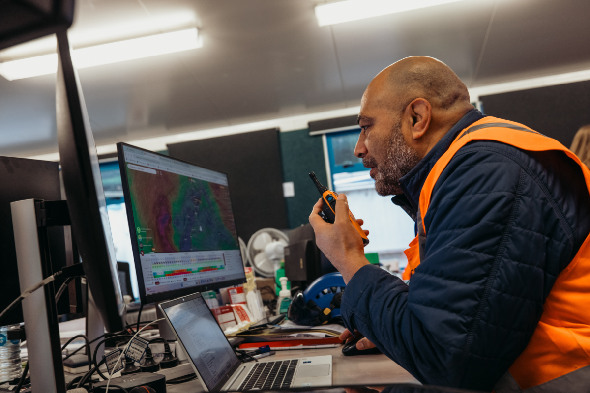 Construction worker at desk reviewing work plans