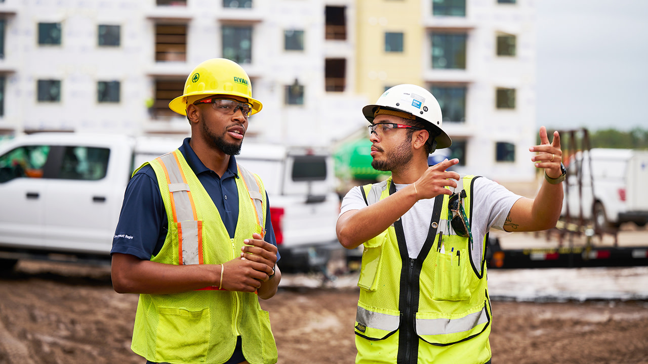 Two construction workers having a conversation