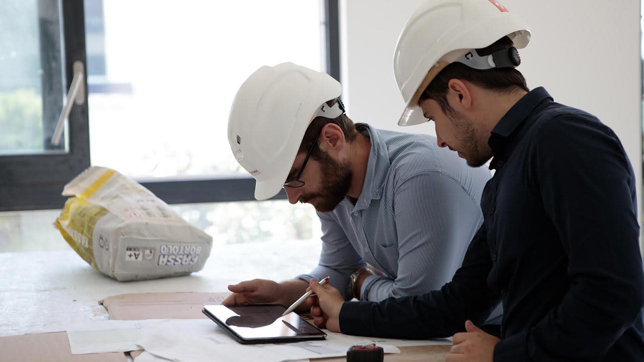 Two contractors working using Procore