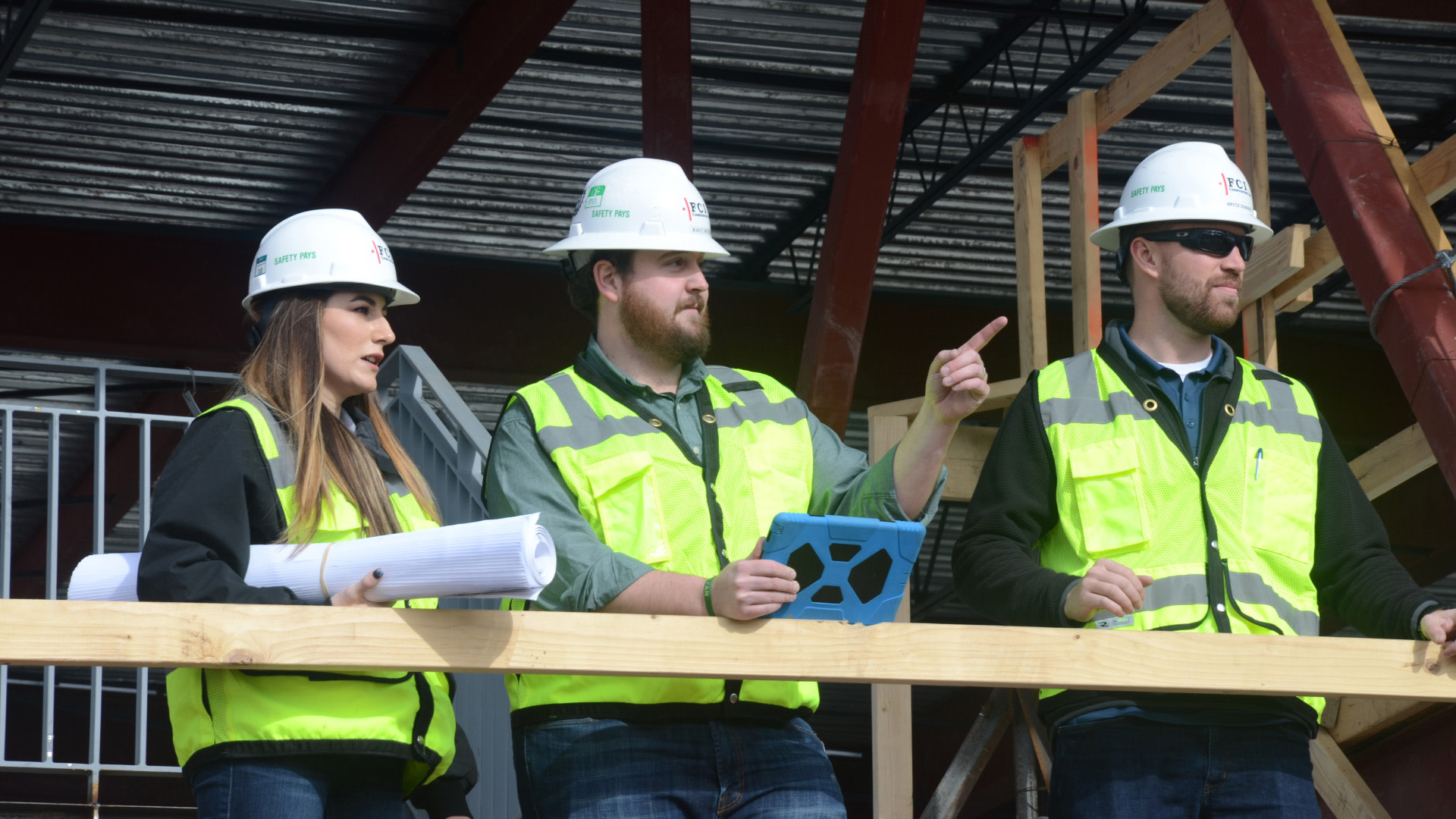 3 FCI Constructors workers standing on a terrace under construction