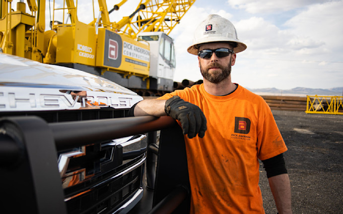 Dick Anderson Employee leaning on truck with crane in background